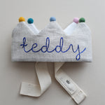 handmade embroidered birthday crown with blue thread and colorful pom poms