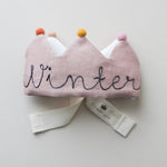 Handmade blush linen birthday crown with gray embroidery and felt pom poms