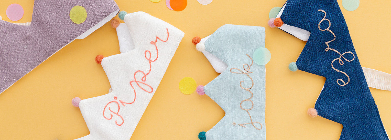 Colorful children's name crowns on a yellow background with confetti.