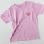 Pink t-shirt with 'Annie' print on a light gray background