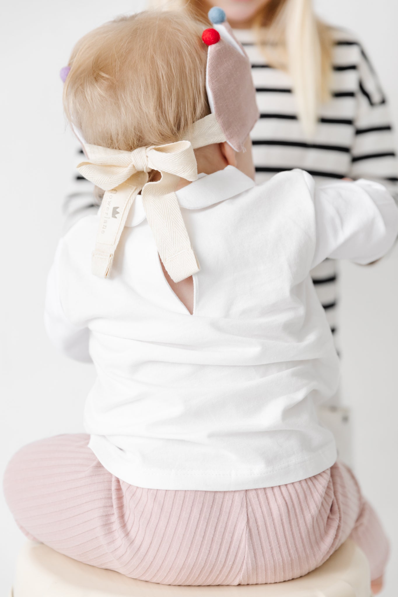 Baby wearing birthday crown in pink.